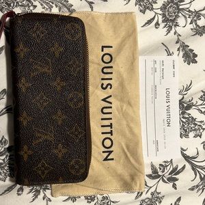 Louis Vuitton Clemence wallet. Monogram outside, fushcia inside.
